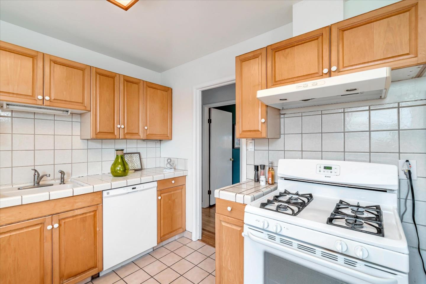 1159 De Solo Drive Pacifica, CA 94044 - Photo 19 of 45 a kitchen with a stove a refrigerator and cabinets
