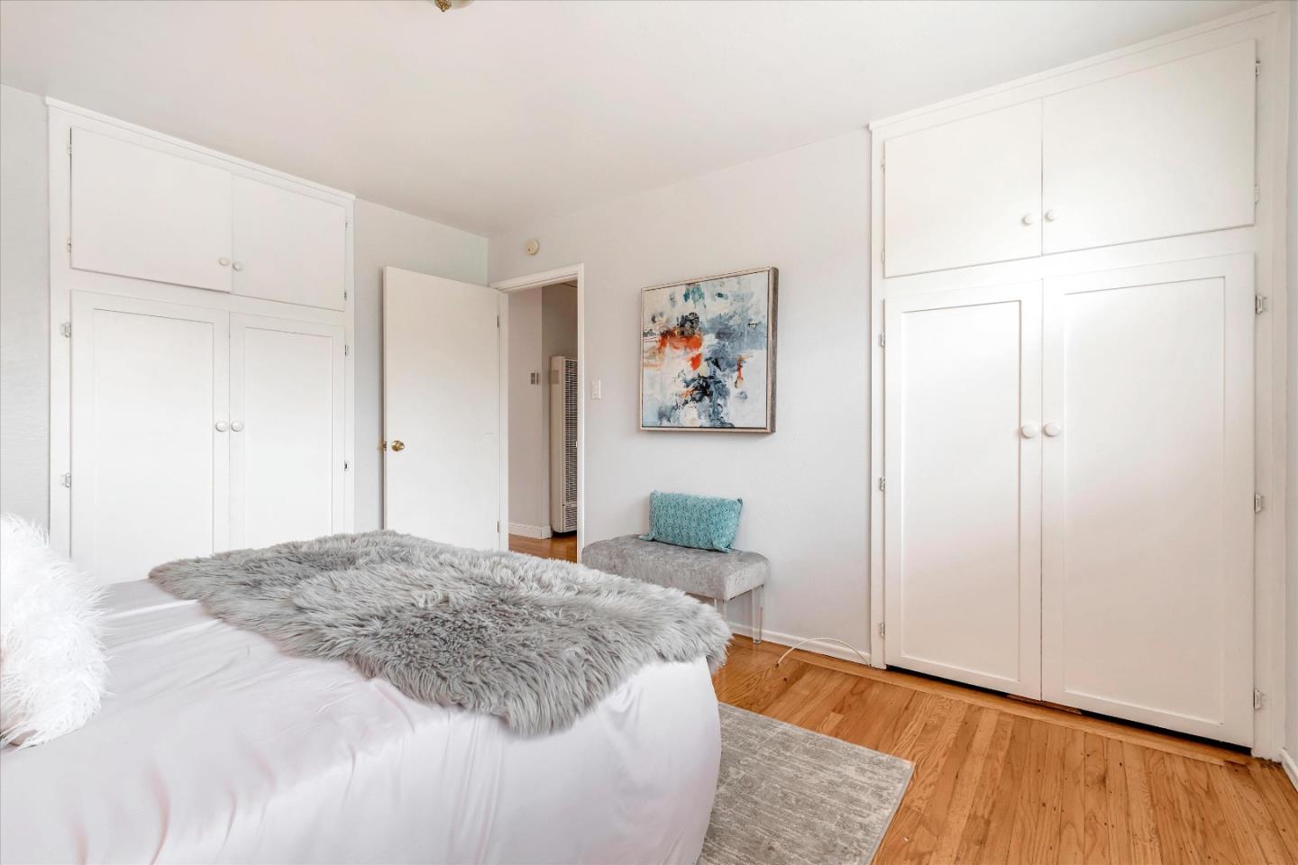 1159 De Solo Drive Pacifica, CA 94044 - Photo 32 of 45 a bedroom with a bed and a painting on the wall