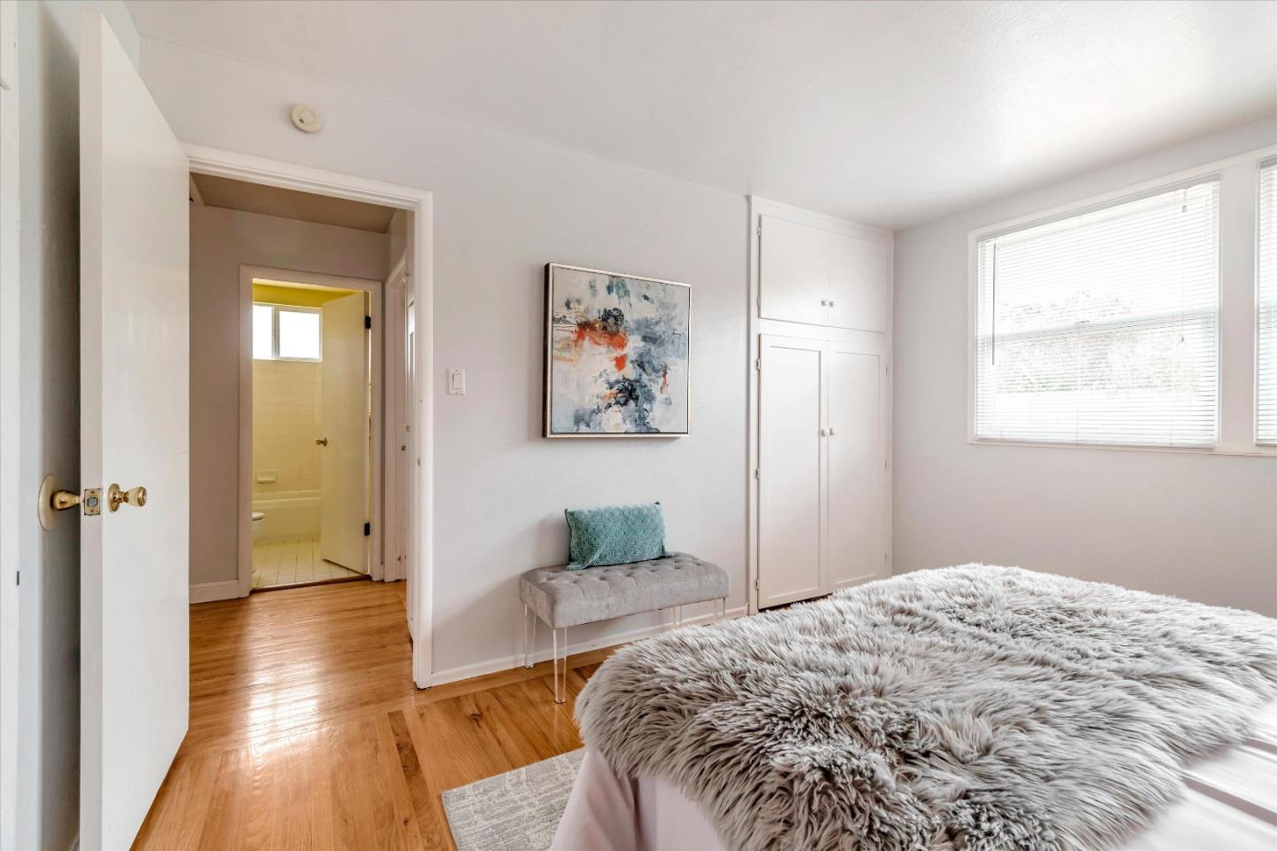 1159 De Solo Drive Pacifica, CA 94044 - Photo 33 of 45 a bedroom with a bed and wooden floor