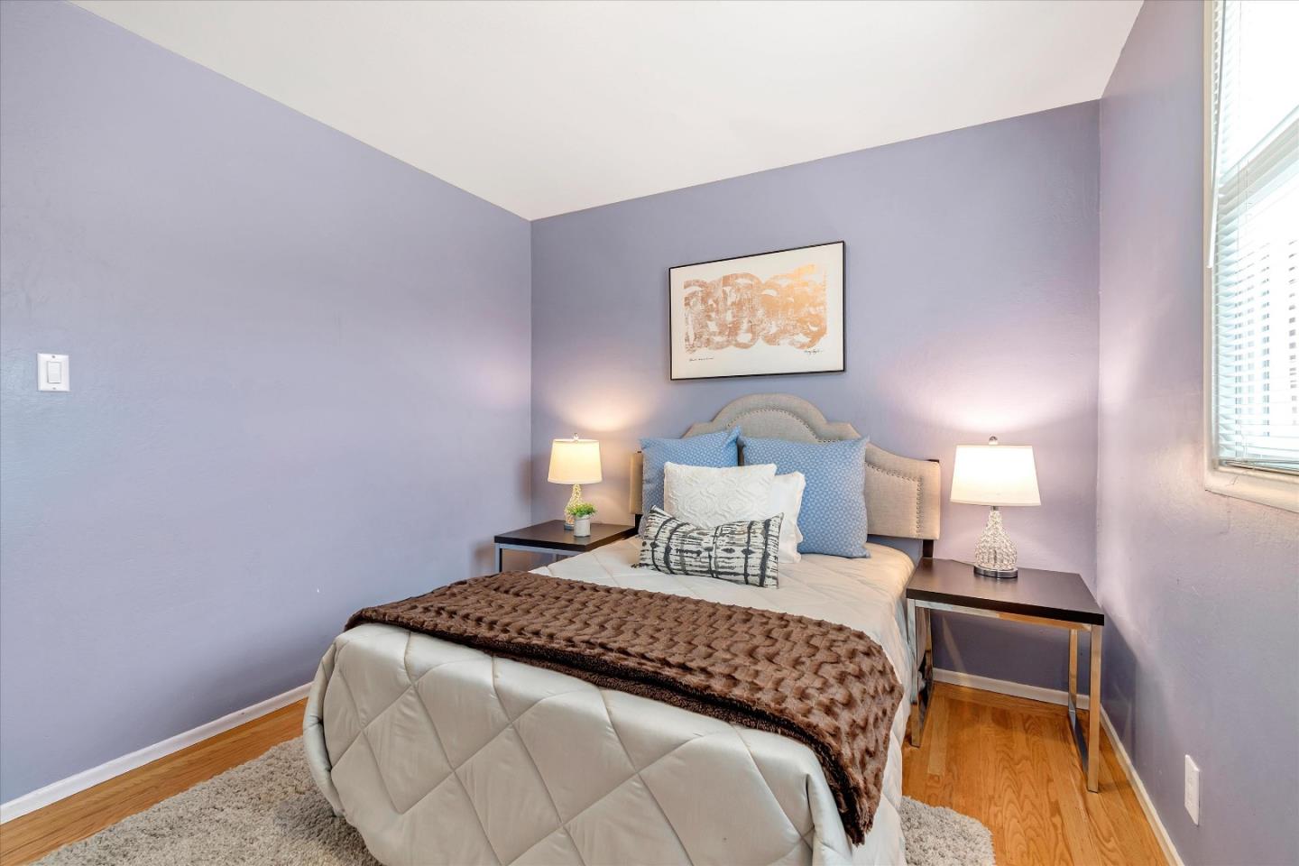 1159 De Solo Drive Pacifica, CA 94044 - Photo 35 of 45 a bedroom with a bed and a night stand