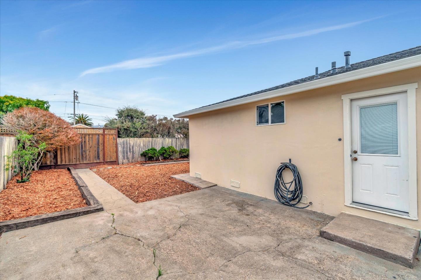 1159 De Solo Drive Pacifica, CA 94044 - Photo 41 of 45 a view of a backyard with plants and brick wall