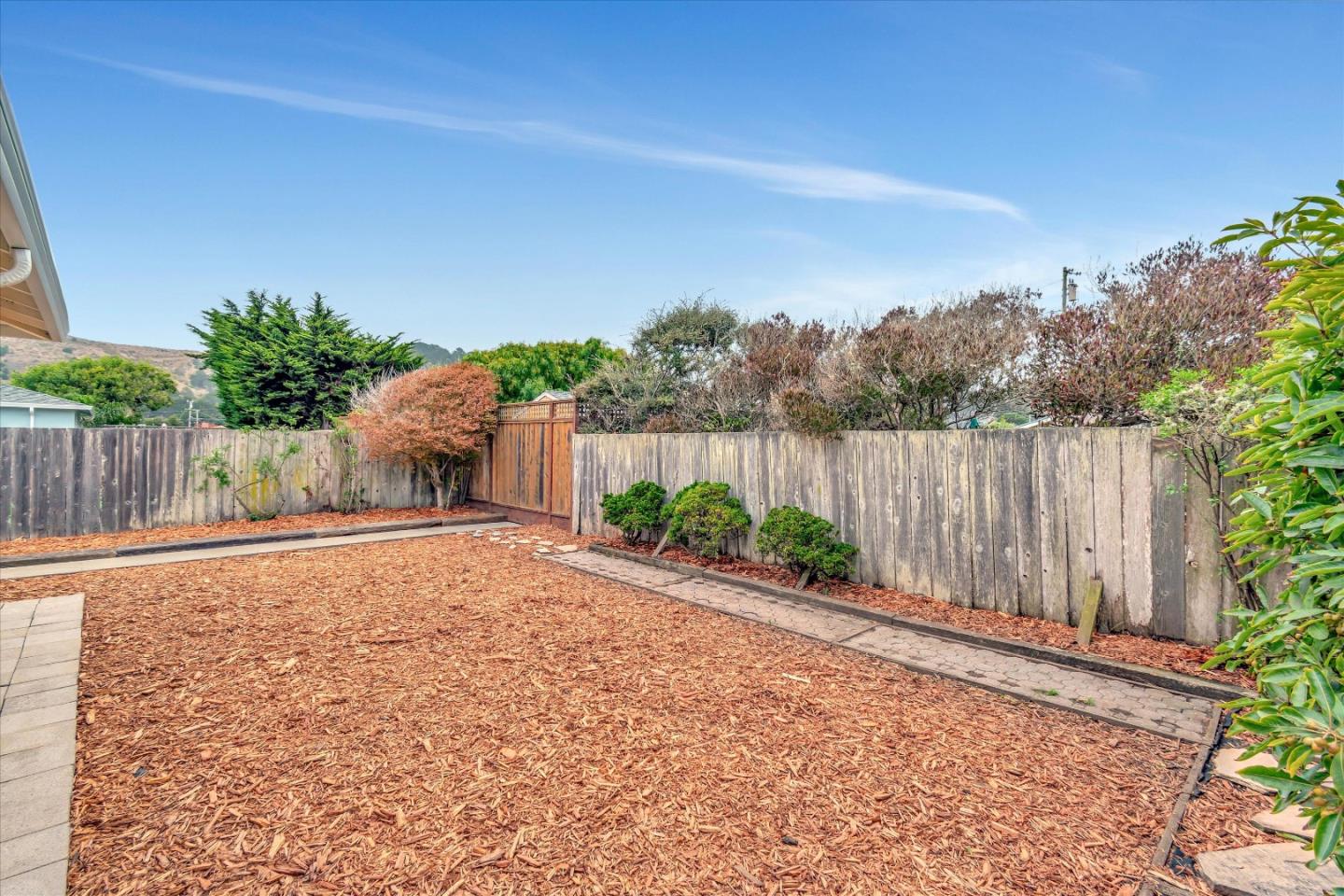 1159 De Solo Drive Pacifica, CA 94044 - Photo 44 of 45 a backyard of a house with lots of green space and wooden fence