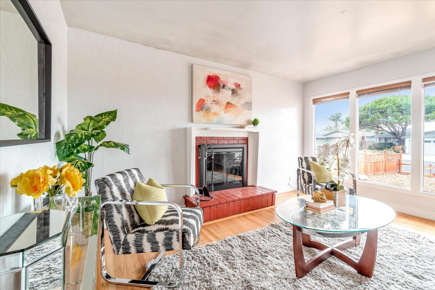 1159 De Solo Drive Pacifica, CA 94044 - Photo 7 of 45 a living room with furniture flowers and a fireplace