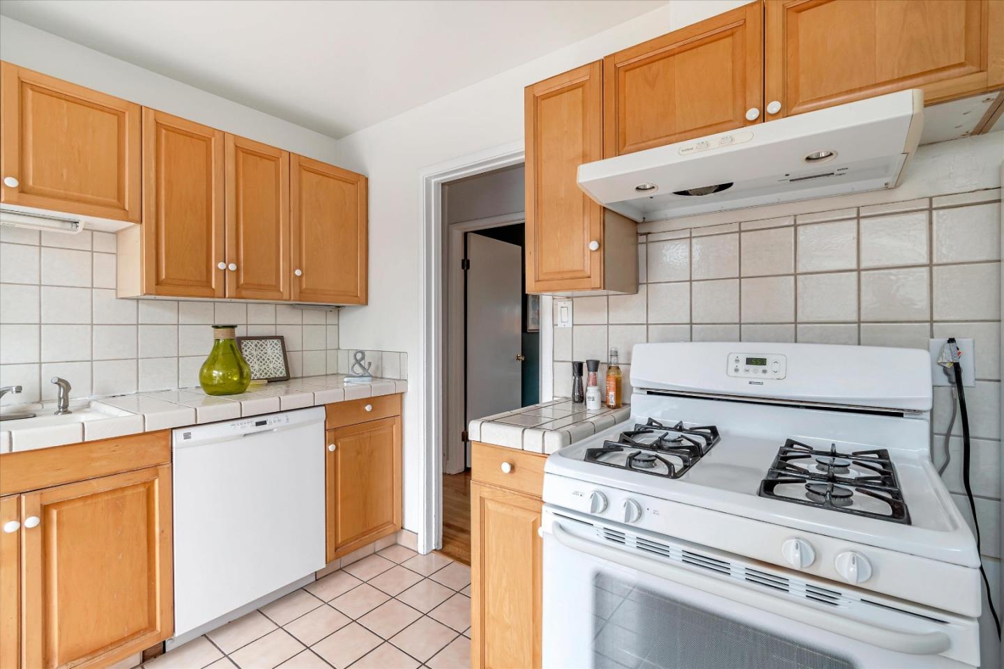 1159 De Solo Drive Pacifica, CA 94044 - Photo 10 of 45 a kitchen with a stove a refrigerator and cabinets