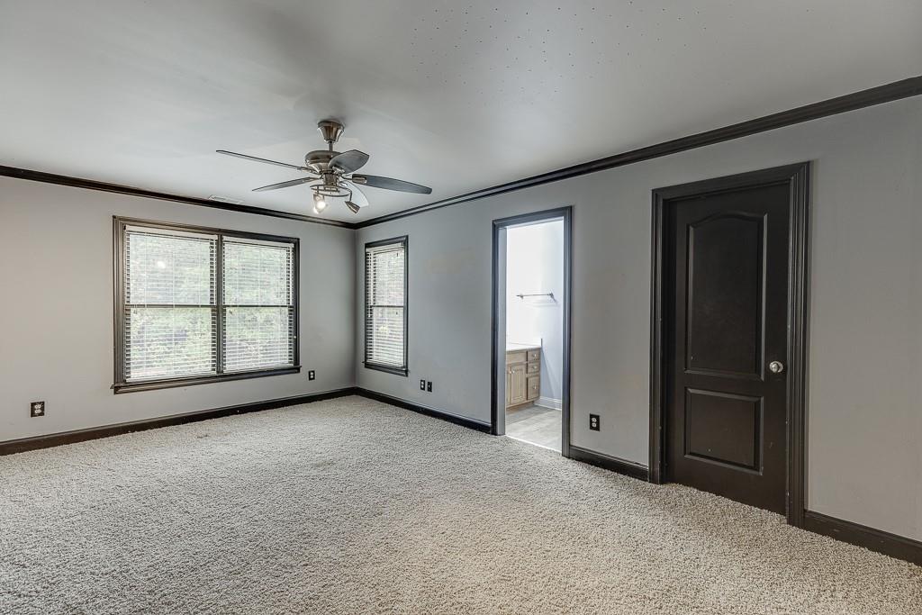 940 Chateau Forest Road Hoschton, GA 30548 - Photo 48 of 87 an empty room with chandelier fan and windows