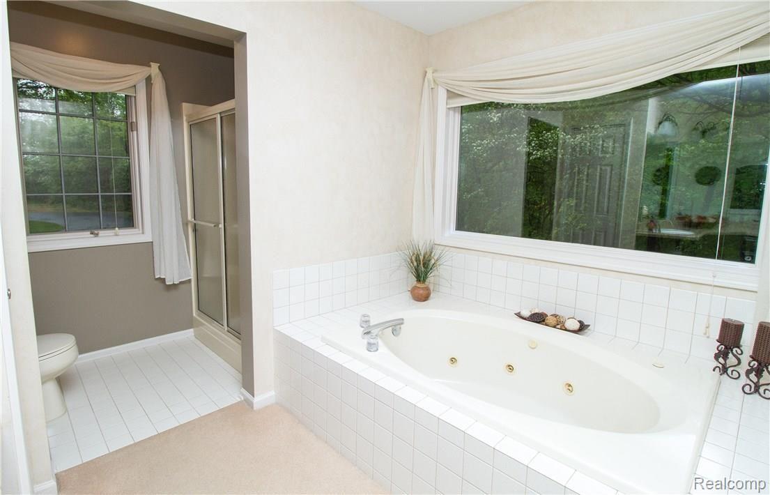 5770 Rochester Road Leonard, MI 48367 - Photo 21 of 54 MASTER SUITE BATHROOM WITH JETTED TUB, SHOWER, & VIEWS!!