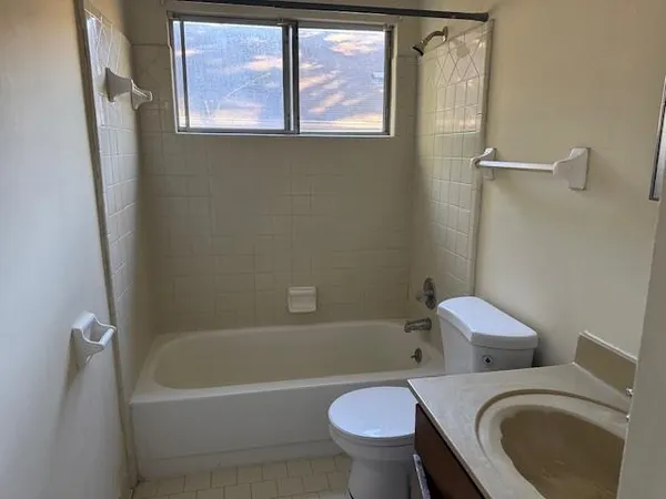 a white bath tub sitting next to a toilet