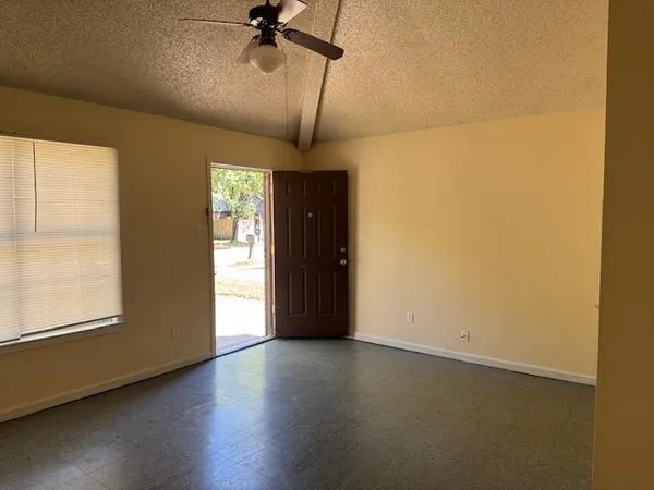 a view of a livingroom with wooden floor and a window