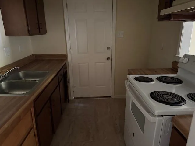 a kitchen with a sink stove and refrigerator