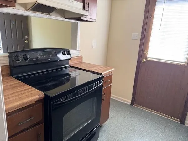 a stove top oven sitting inside of a kitchen