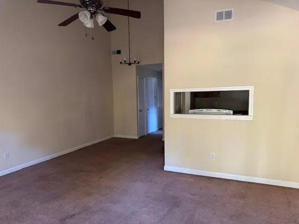 a view of a livingroom with a microwave and a wall