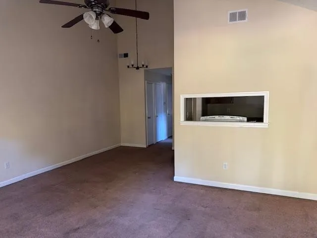 a view of a livingroom with a microwave and a wall