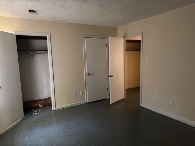 a view of empty room with closet and window