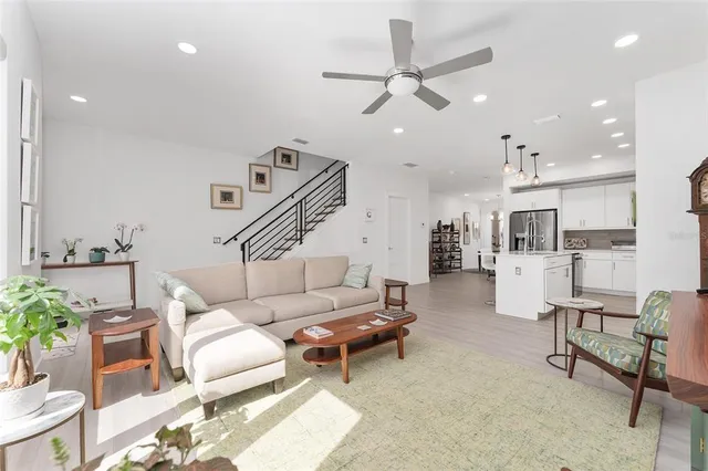 a living room with furniture and kitchen view