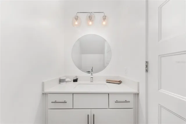 a view of a hallway with stairs and a rug