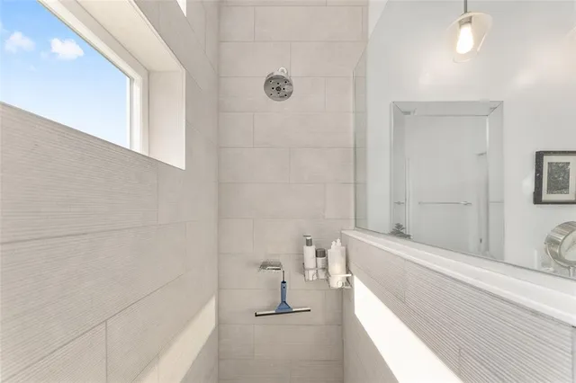 a bathroom with a sink a toilet and mirror