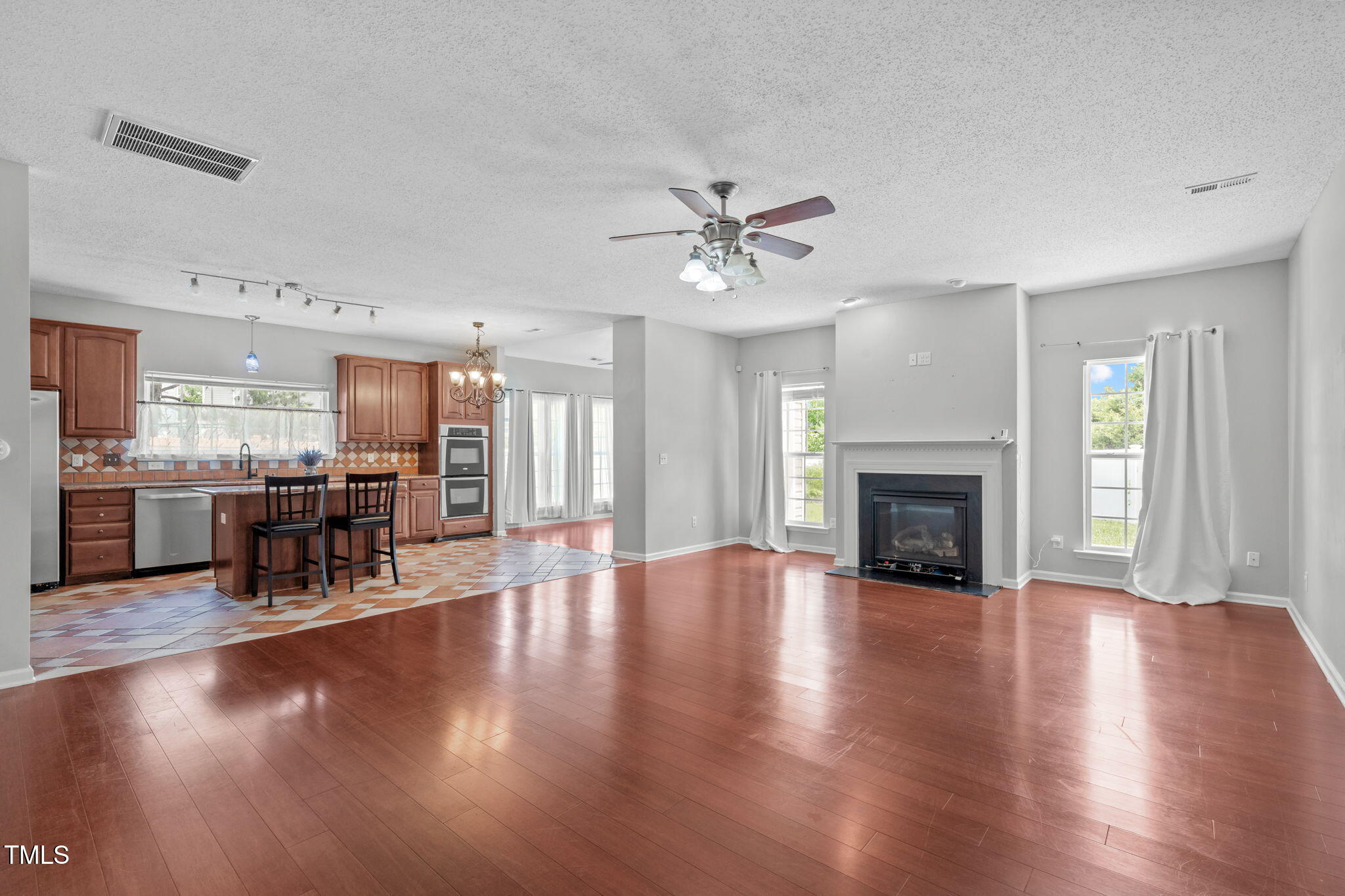 760 Stackhurst Way Wake Forest, NC 27587 - Photo 2 of 37 a view of a livingroom with furniture a fireplace wooden floor and a window