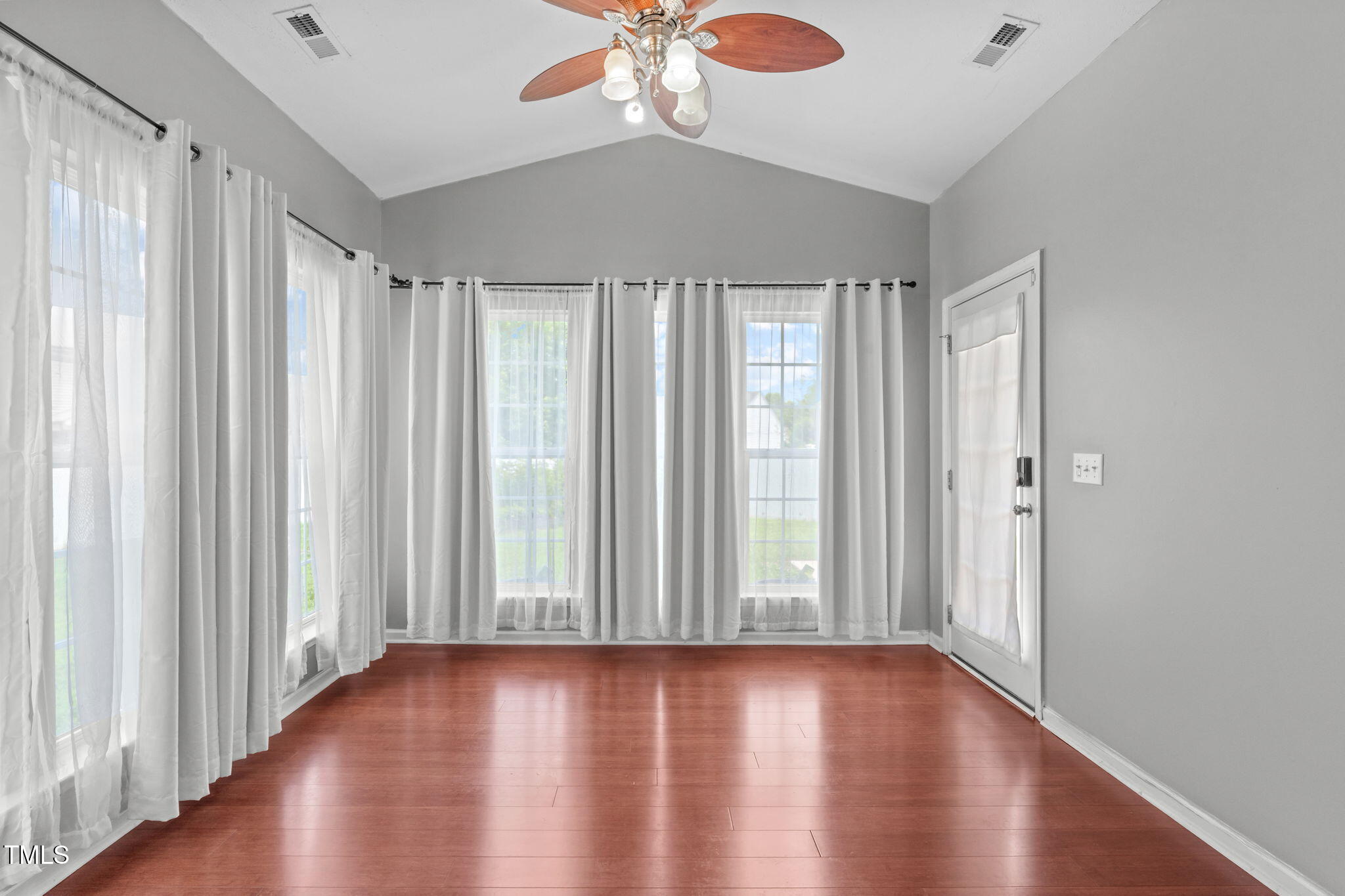 760 Stackhurst Way Wake Forest, NC 27587 - Photo 4 of 37 a view of a livingroom with wooden floor and a ceiling fan