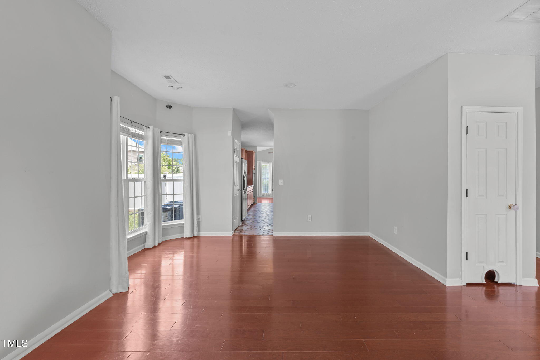 760 Stackhurst Way Wake Forest, NC 27587 - Photo 9 of 37 a view of an empty room with wooden floor and a window