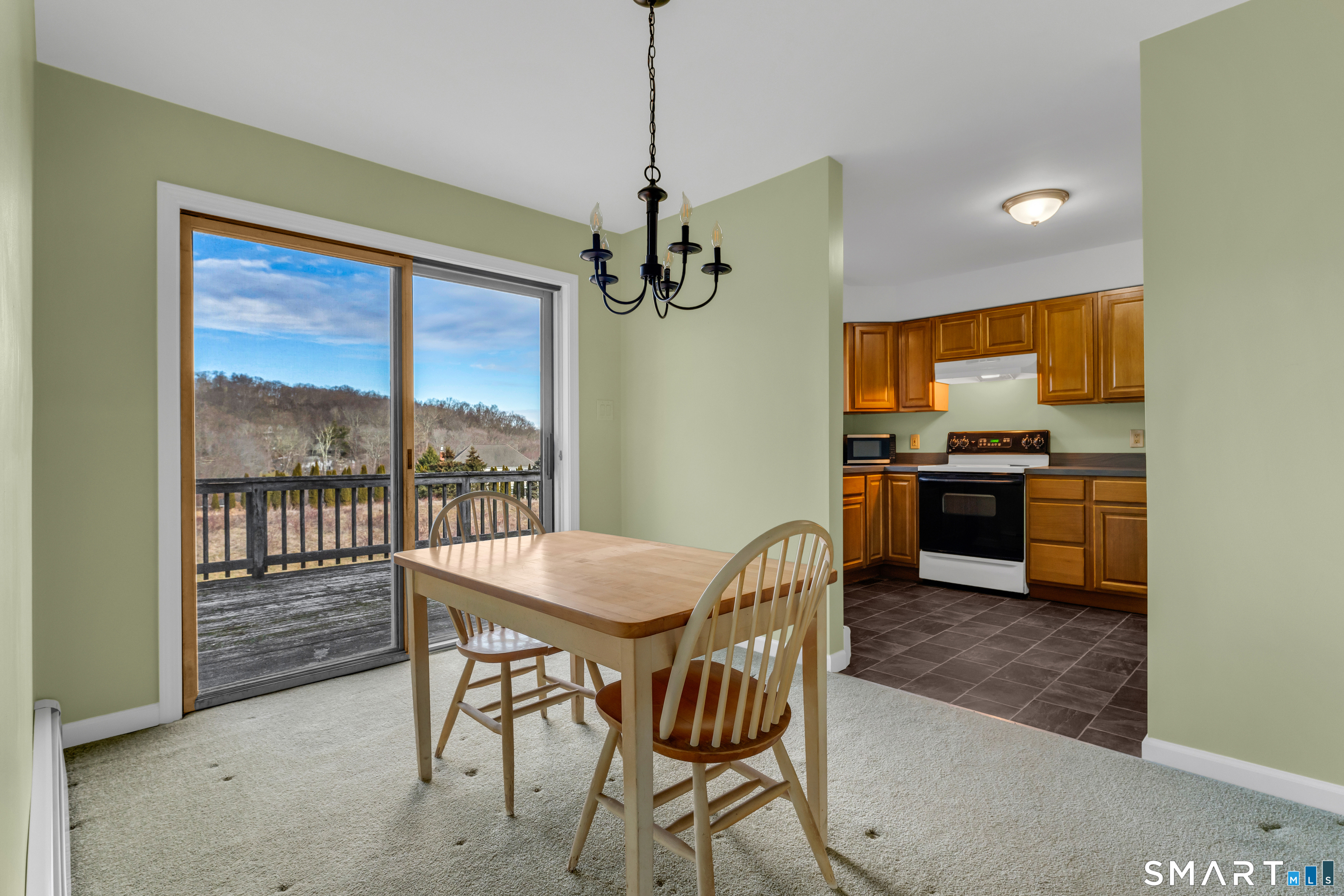 250 Elm Street Guilford, CT 06437 - Photo 5 of 25 a view of a dining room with furniture large windows and wooden floor