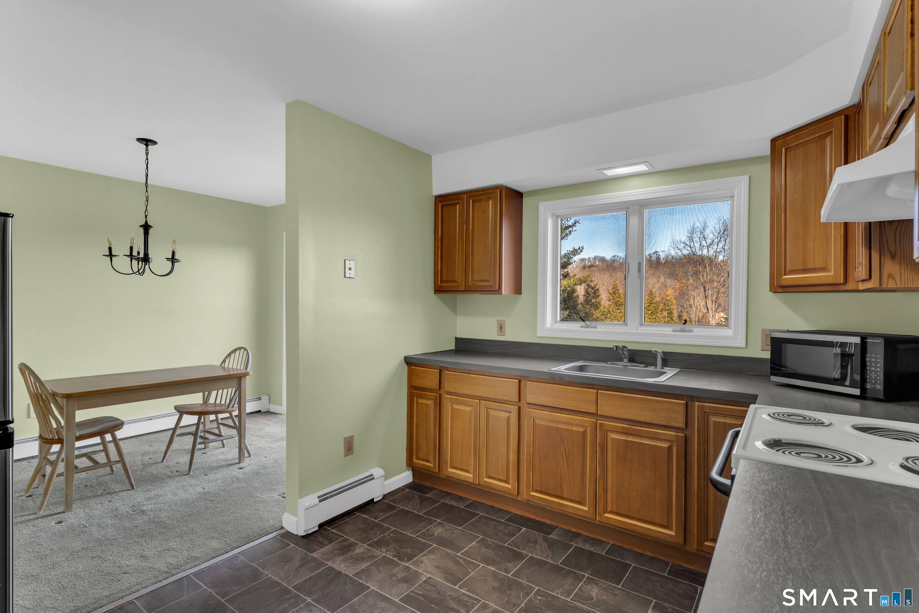 250 Elm Street Guilford, CT 06437 - Photo 7 of 25 a kitchen with sink cabinets and window