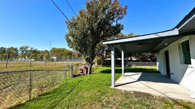 a view of a swimming pool with a patio and a yard
