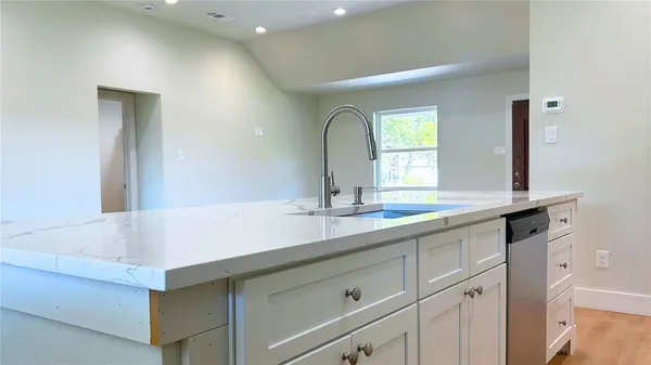 a bathroom with a sink and a large mirror