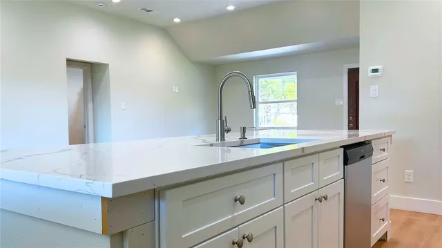 a bathroom with a sink and a large mirror
