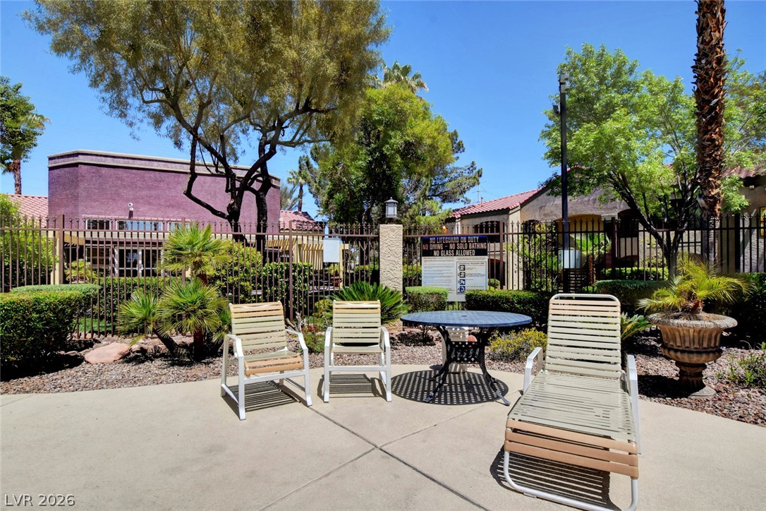 7885 West Flamingo Road, Unit 1050 Las Vegas, NV 89147 - Photo 47 of 62 Lush landscaping and paved lounge area complement this inviting community outdoor space.