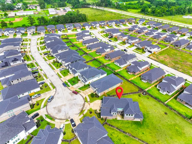 a view of a swimming pool with a yard and plants