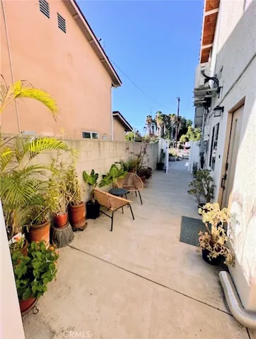 a view of a terrace with furniture and a garden
