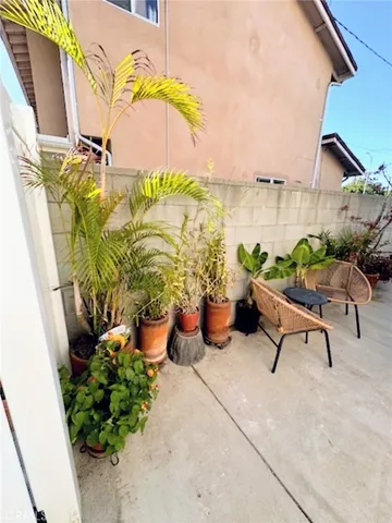 a view of a patio with plants and furniture