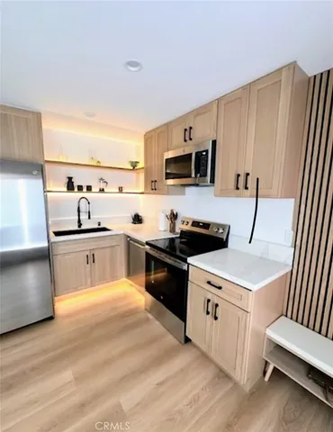 a kitchen with a sink and a stove top oven