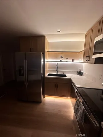 a kitchen with a refrigerator and a sink