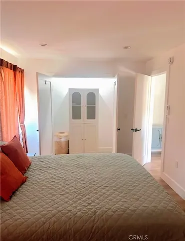 a large bedroom with a bed and a couch