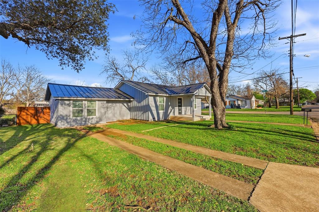 502 Madison Street Cleburne, TX 76033 - Photo 3 of 30 a front view of a house with a yard