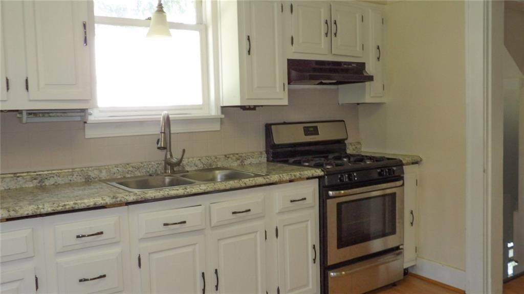 887 Quarry Place Sharon, PA 16146 - Photo 4 of 15 a kitchen with granite countertop a sink and a stove
