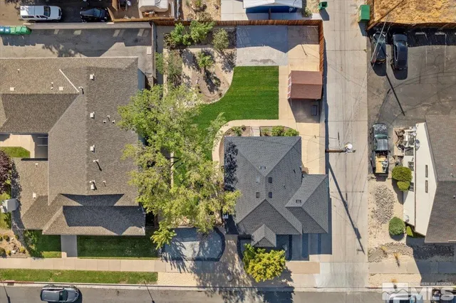 an aerial view of residential houses with outdoor space and parking