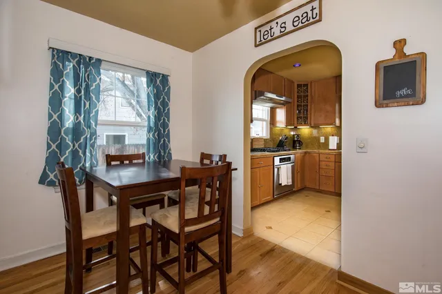 a view of a dining room with furniture and a large window