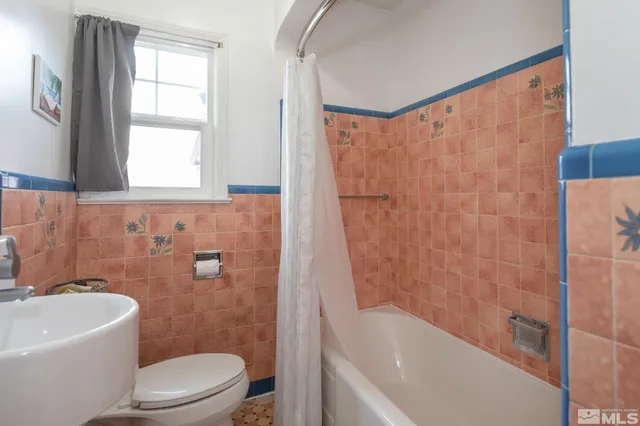 a bathroom with a bathtub toilet and sink