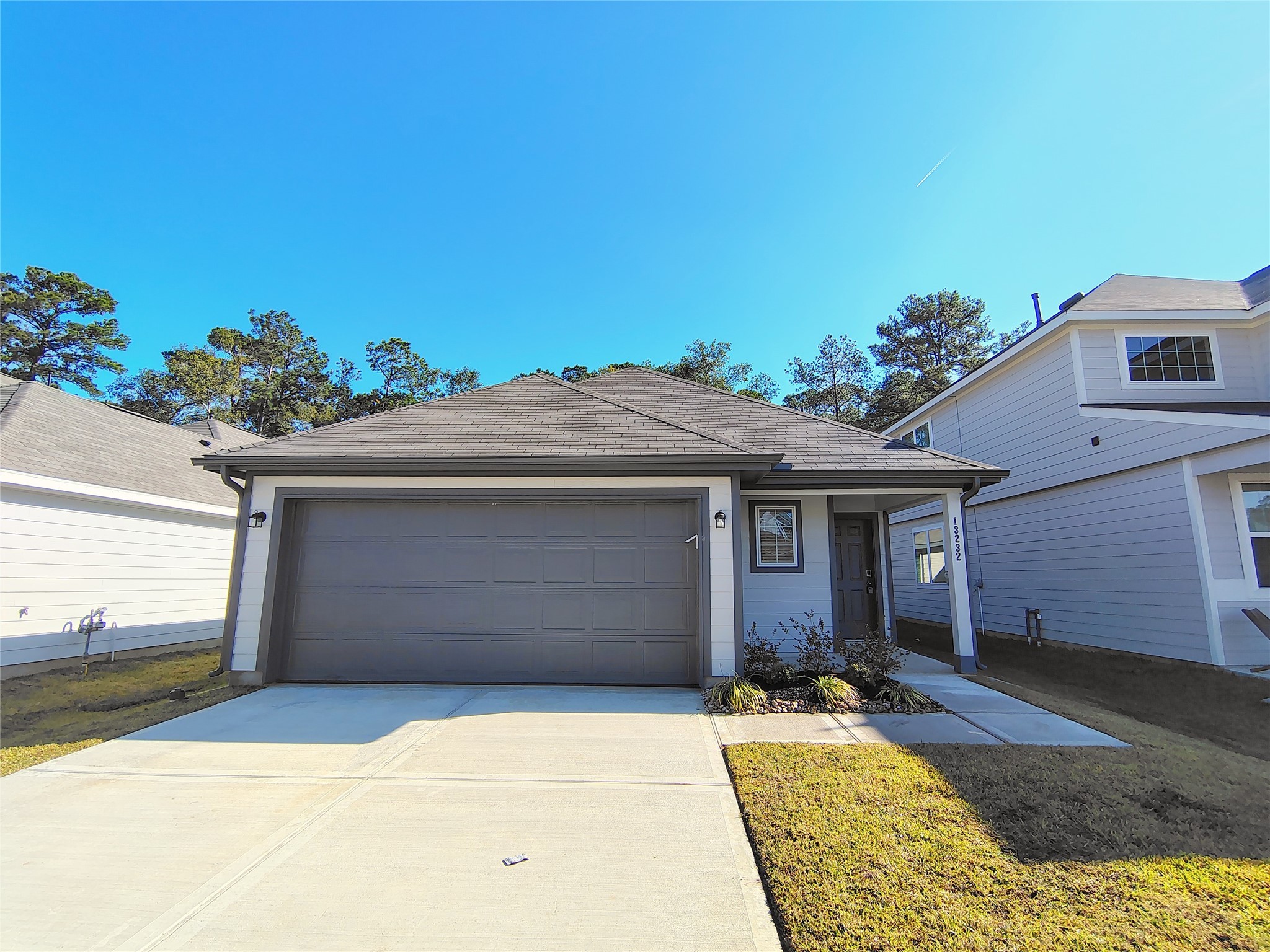 a front view of a house with a yard and garage