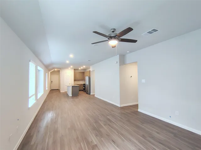 a view of a livingroom with a ceiling fan and window
