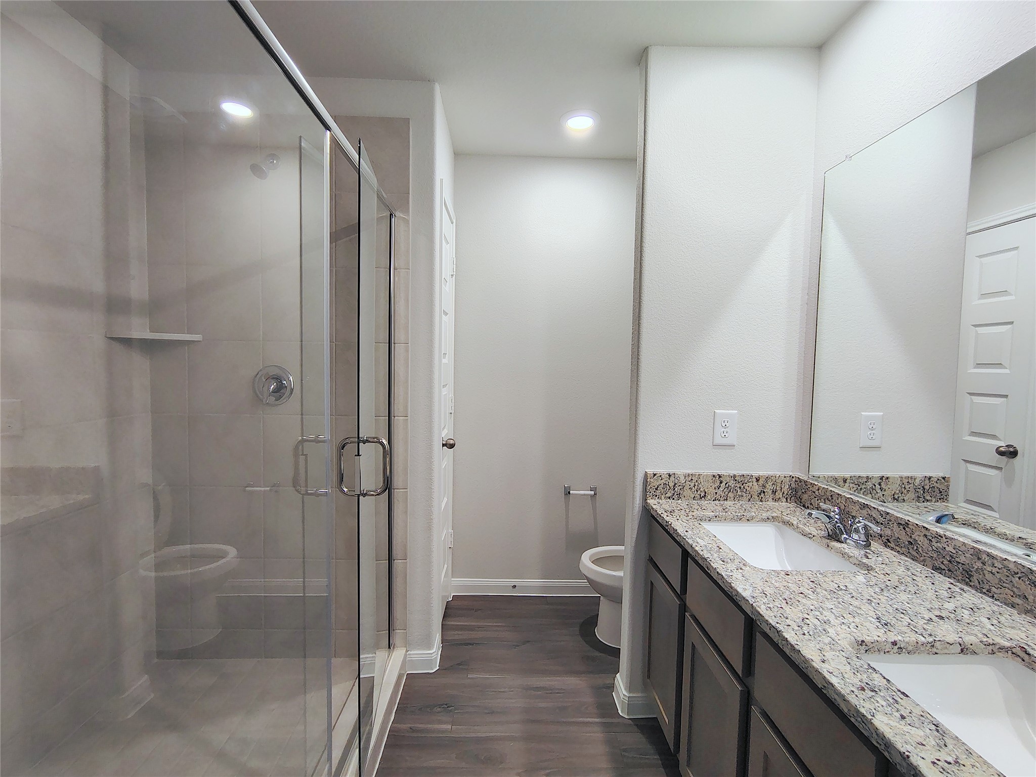 13232 Musky Drive Conroe, TX 77384 - Photo 13 of 18 a bathroom with a granite countertop sink a toilet and shower