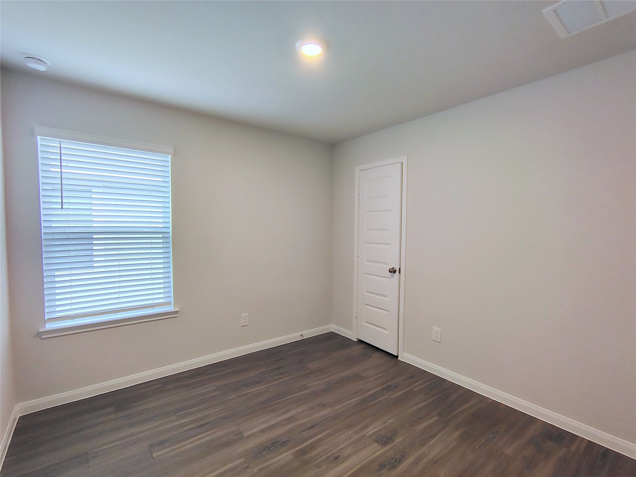 13232 Musky Drive Conroe, TX 77384 - Photo 15 of 18 an empty room with wooden floor and windows