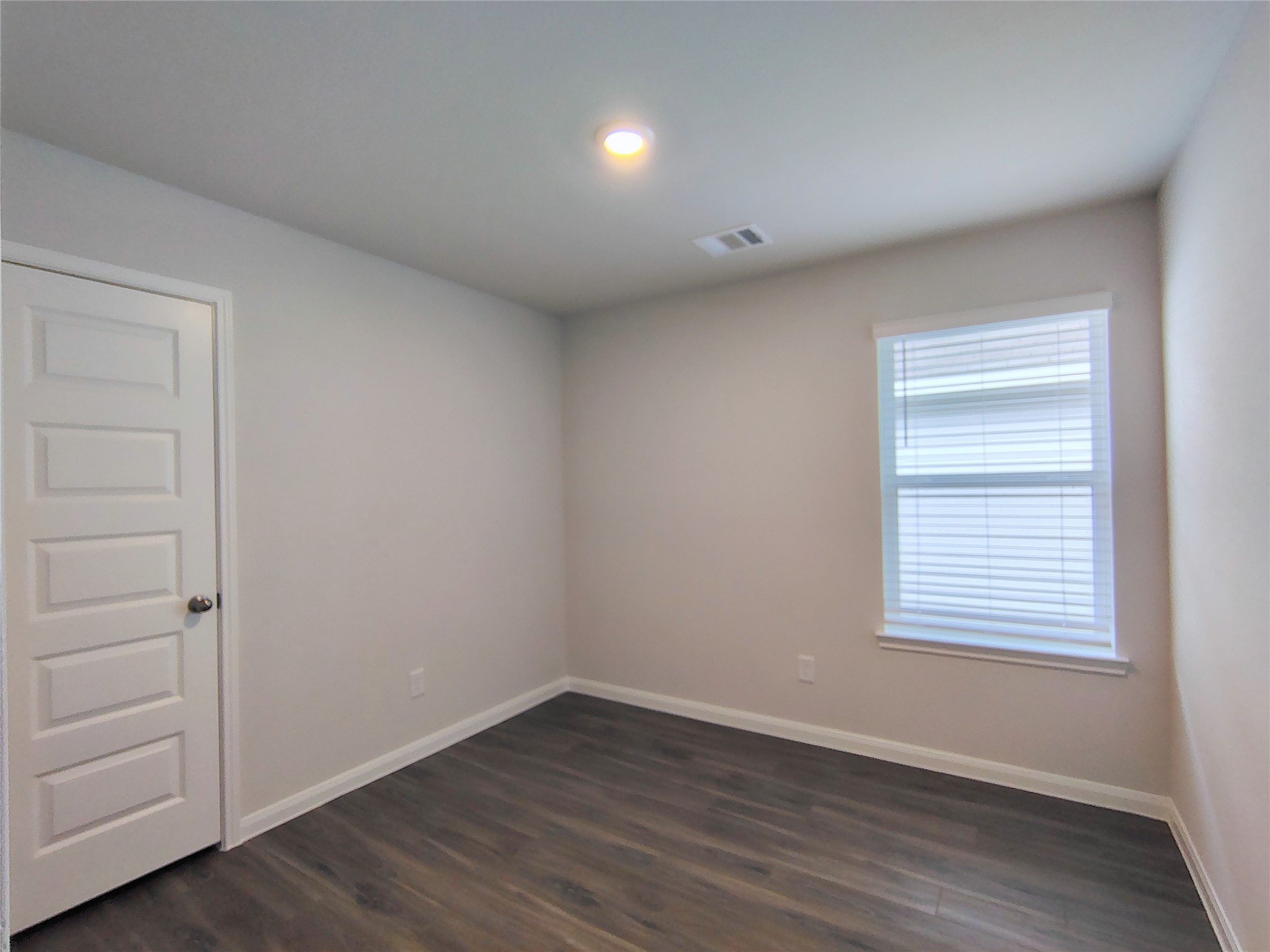 13232 Musky Drive Conroe, TX 77384 - Photo 16 of 18 an empty room with wooden floor and windows