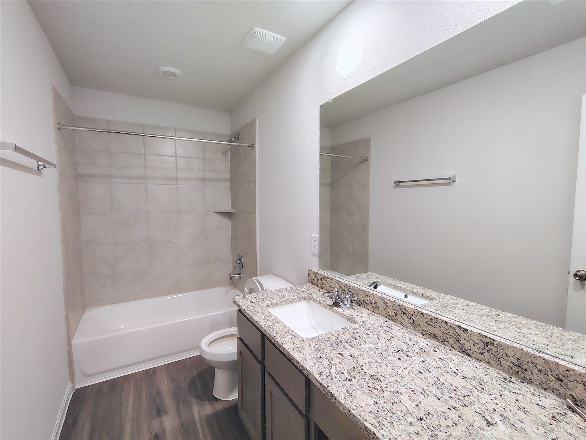 13232 Musky Drive Conroe, TX 77384 - Photo 17 of 18 a bathroom with a granite countertop sink a toilet and bathtub