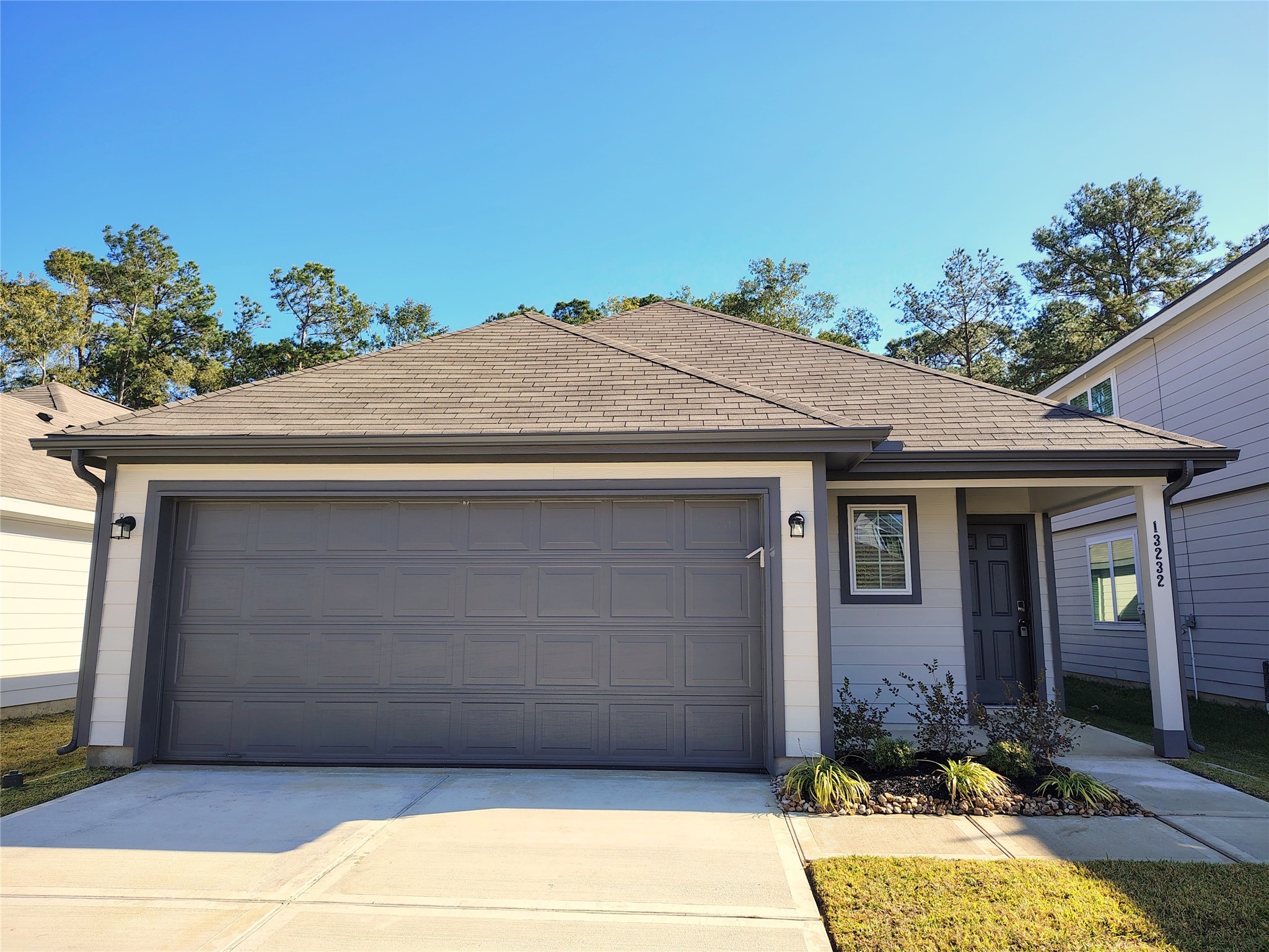 13232 Musky Drive Conroe, TX 77384 - Photo 2 of 18 a front view of a house with a yard