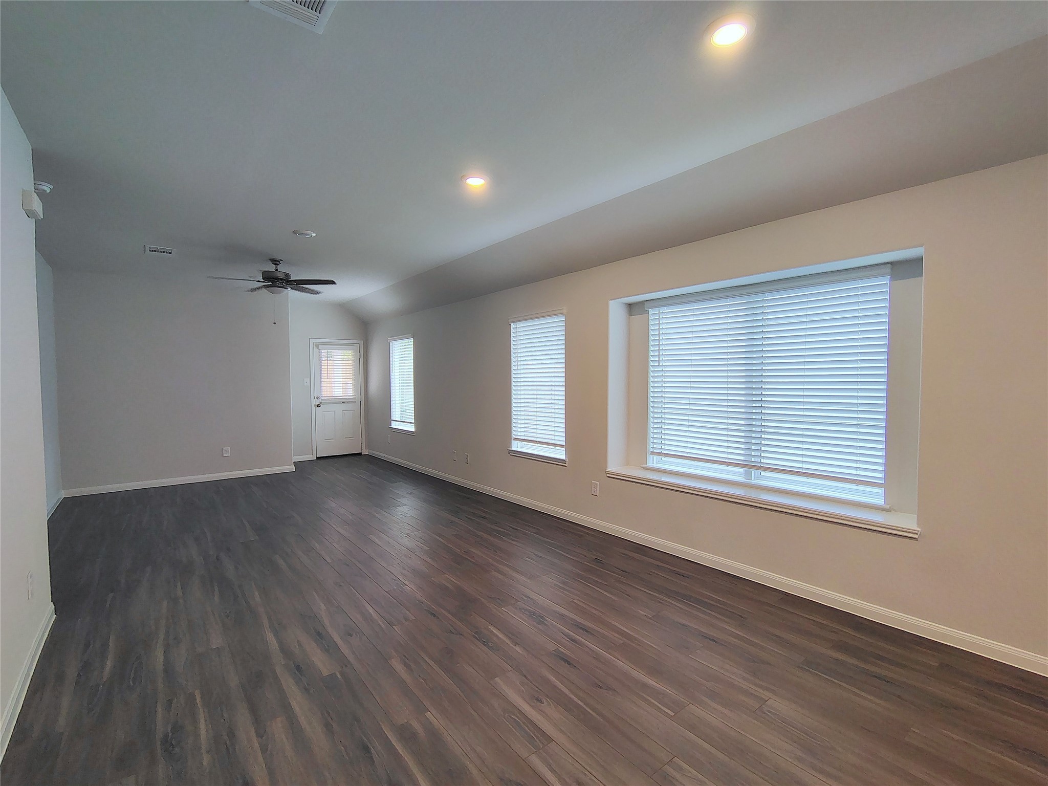 13232 Musky Drive Conroe, TX 77384 - Photo 4 of 18 an empty room with wooden floor and windows