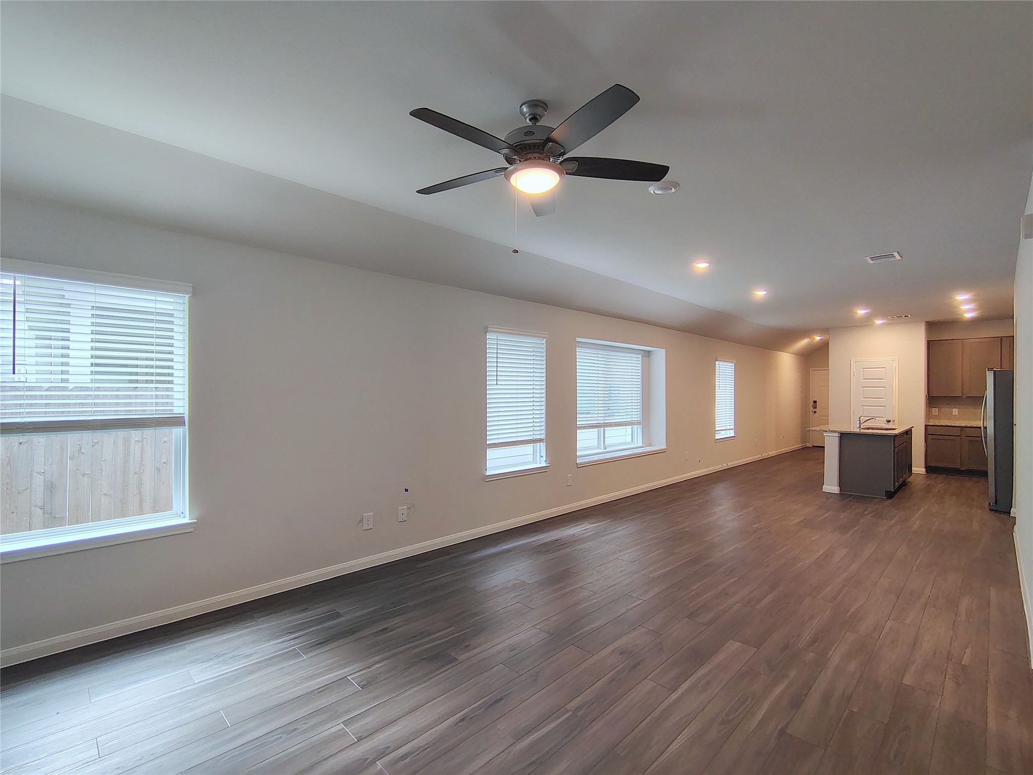 13232 Musky Drive Conroe, TX 77384 - Photo 10 of 18 a view of an empty room with wooden floor and a window