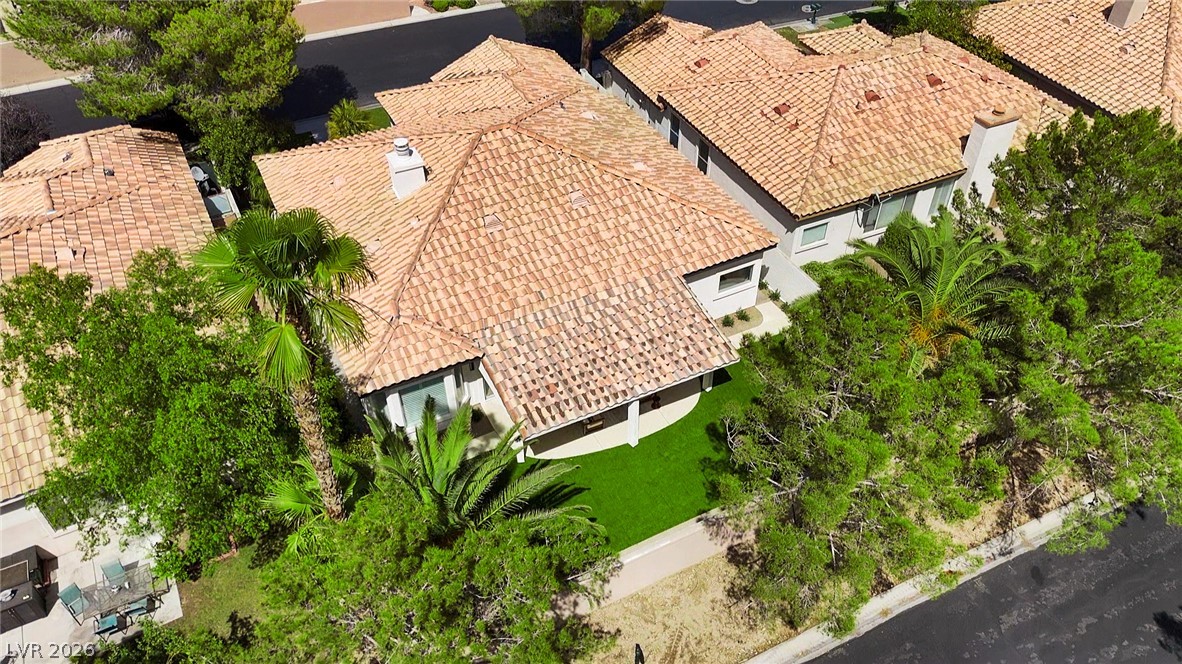 8981 Rivers Edge Drive Las Vegas, NV 89117 - Photo 61 of 69 An aerial perspective reveals the home's tiled roof and verdant landscaping, offering a private oasis.